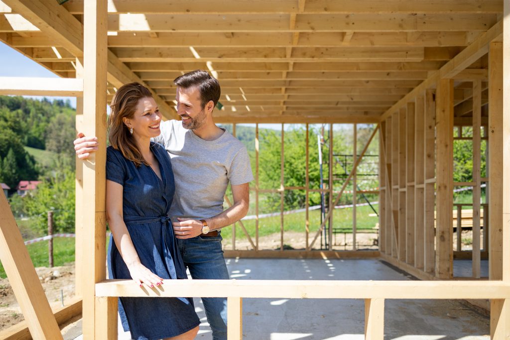 House and Land for Sale - woman and man on wooden support