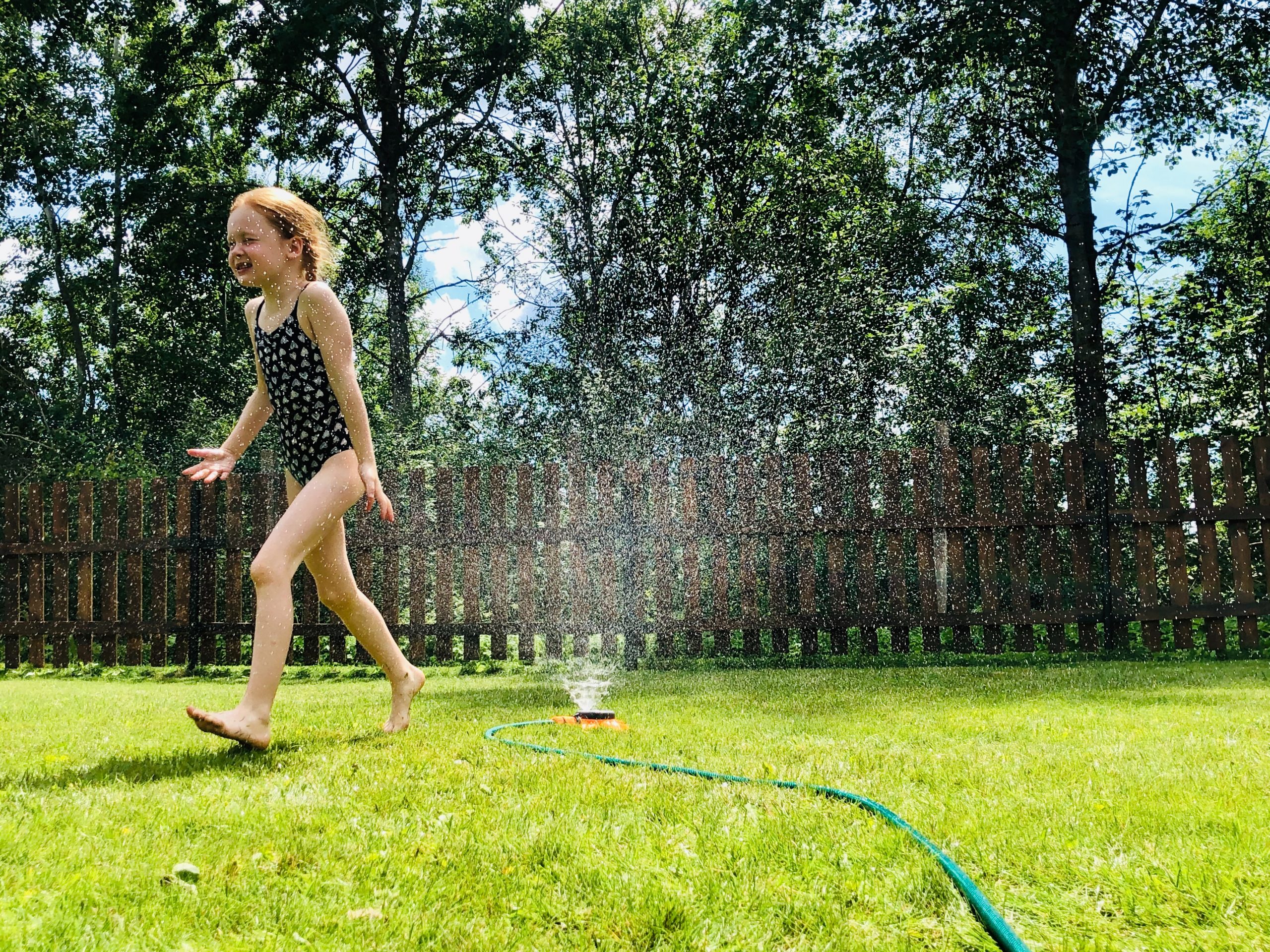 Development Land for Sale - child in garden with hose on